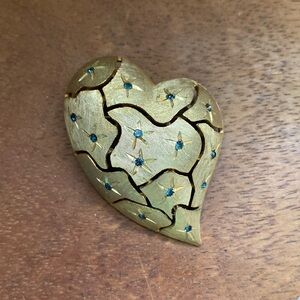 Large JJ broken heart brooch features blue rhinestones.
